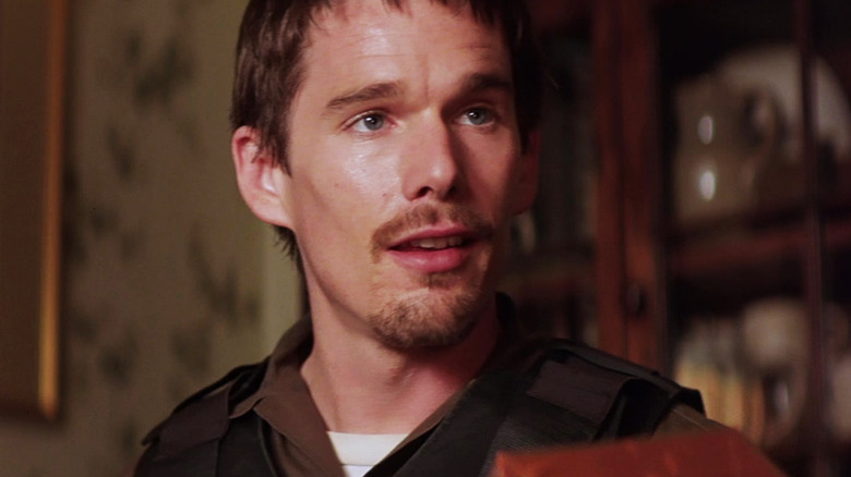Ethan Hawke's Jake Hoyt looks off to his left as he sits in a house in Training Day