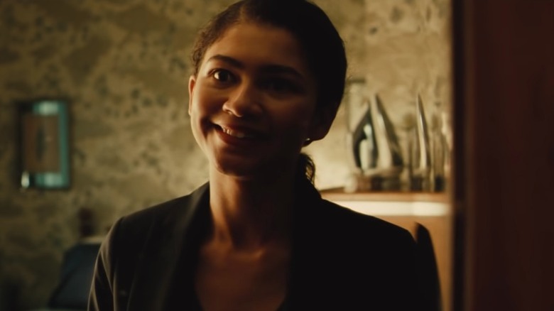 Rue smiling unnervingly black suit