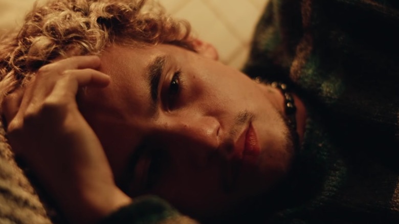 Elliot laying down hand forehead