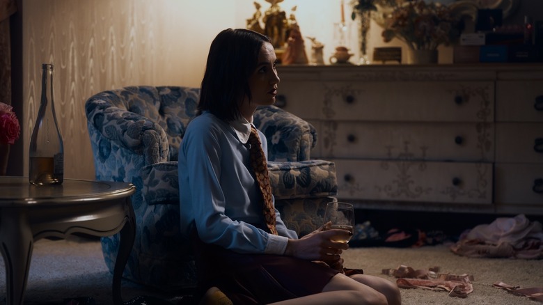 Lexi watching TV with a glass of rose on Euphoria