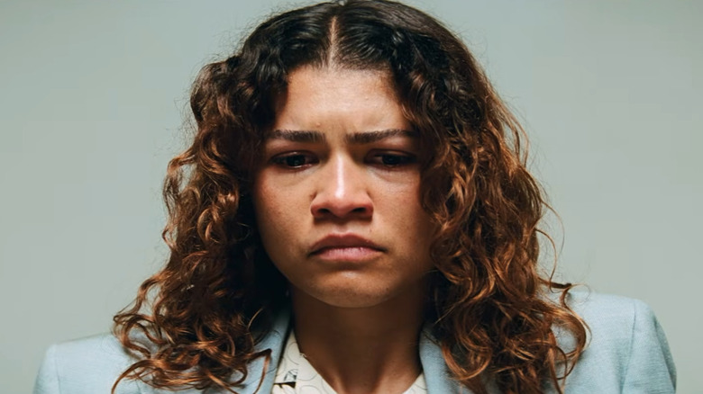 Rue (Zendaya) sits in an interrogation room in Euphoria season 3