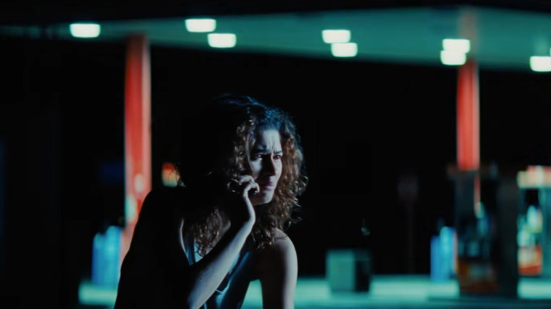Rue (Zendaya) cries on the phone in front of a gas station in Euphoria season 3