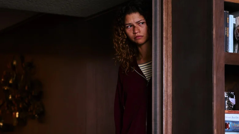 Zendaya peeking around a corner with a bloody nose on Euphoria