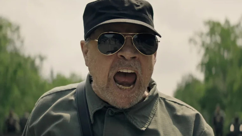 Mark Hamill's the Major wearing aviator sunglasses and screaming in The Long Walk