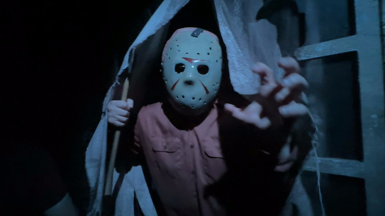 Jason holds an axe in the Jason maze at Halloween Horror Nights