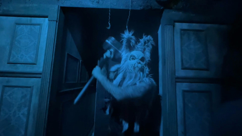 A man in a rabbit mask wields a hammer at Halloween Horror Nights