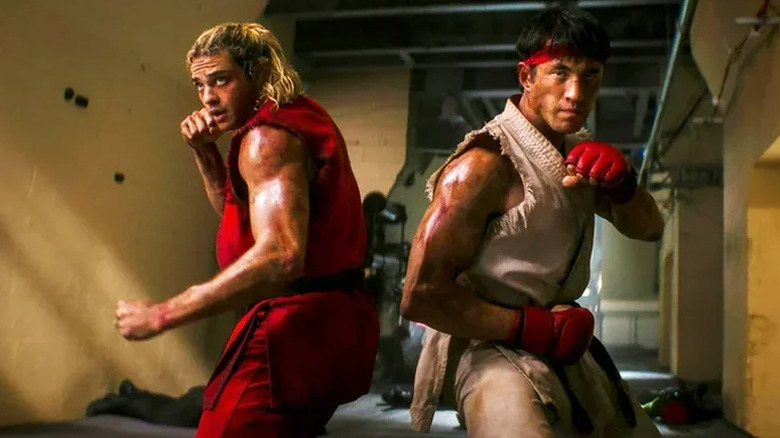 Noah Centineo as Ken standing back to back with Andrew Koji as Ryu with their fists up ready to fight in Street Fighter (2026)