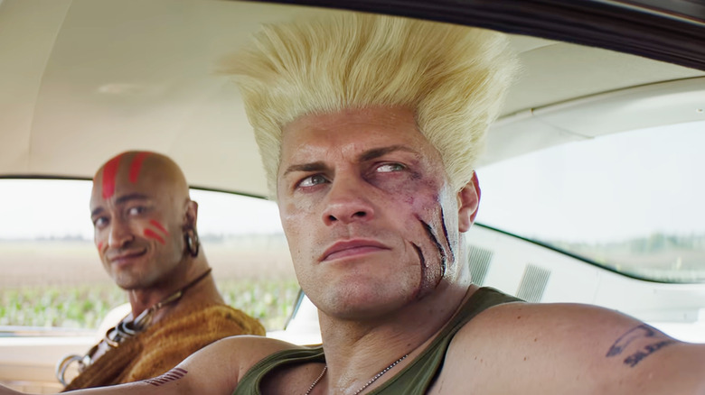 Cody Rhodes as Guile sitting in a car next to Vidyut Jammwal as Dhalsim in Street Fighter (2026)