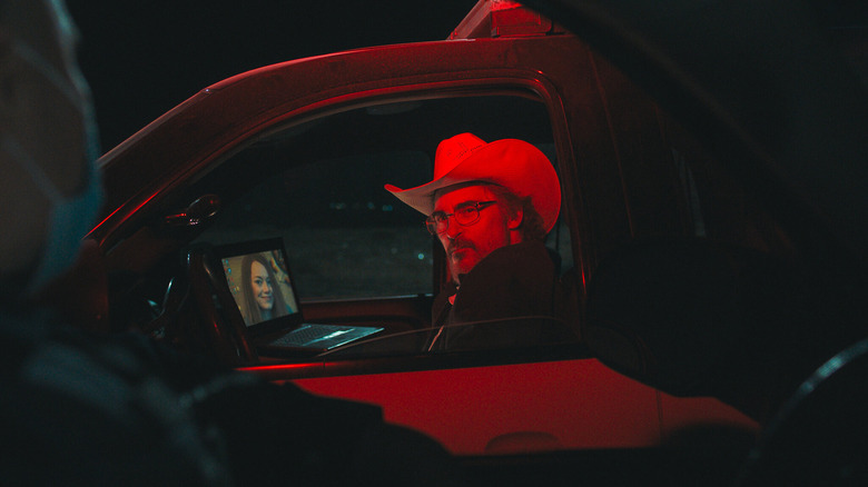 Sheriff Joe Cross sitting in car in red light at night