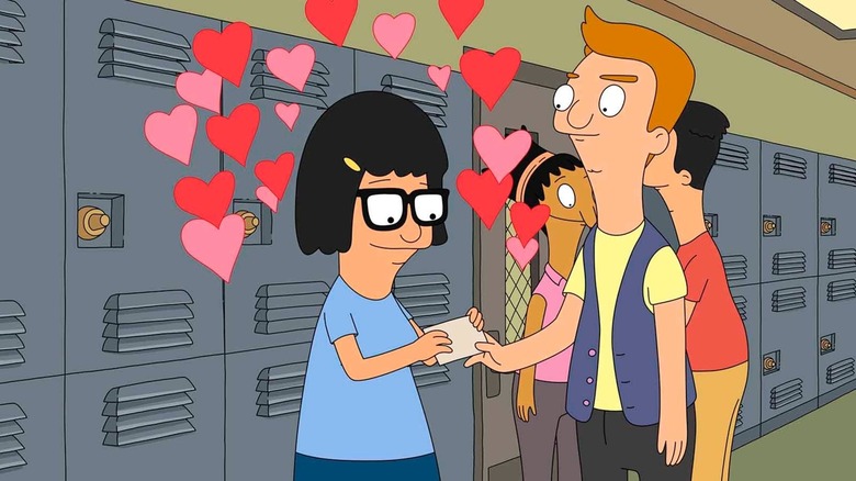 Tina takes a card from Jimmy Jr, hearts floating around her head