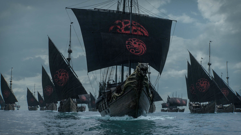 A fleet of ships bearing the Targaryen banner sailing the sea in Game of Thrones