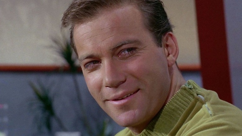 James T. Kirk (William Shatner) smiles as he turns his head in Star Trek: The Original Series