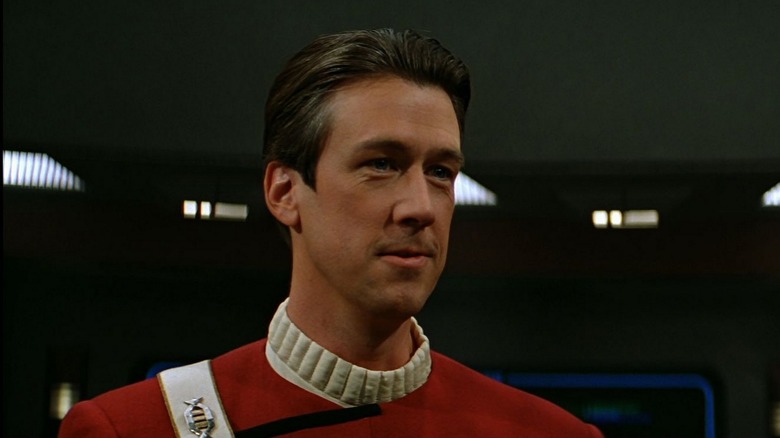 John Harriman (Alan Ruck) stands smiling on the bridge in Star Trek Generations