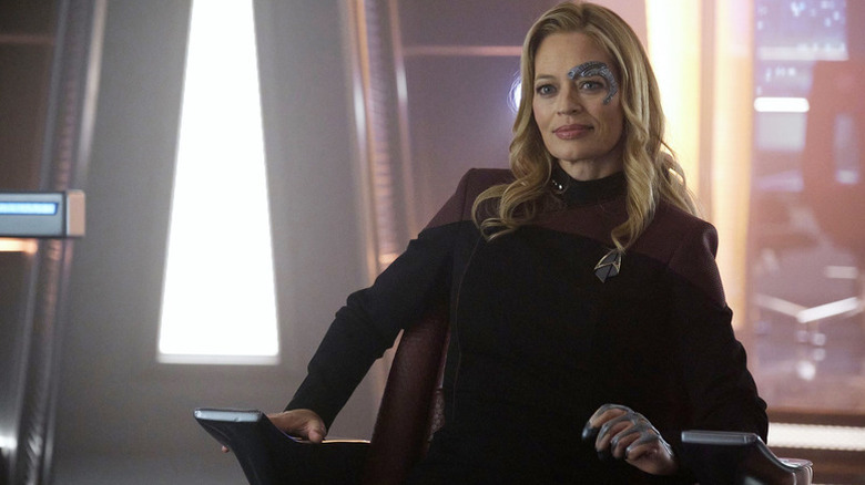 Seven of Nine (Jeri Ryan) sits smiling in a captain's chair in Star Trek: Picard