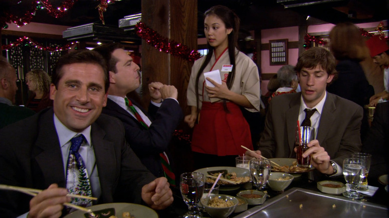 Cindy (Brittany Ishibashi) serving Michael (Steve Carell), Andy (Ed Helms), and Jim (John Krasinski) at Benihana on The Office