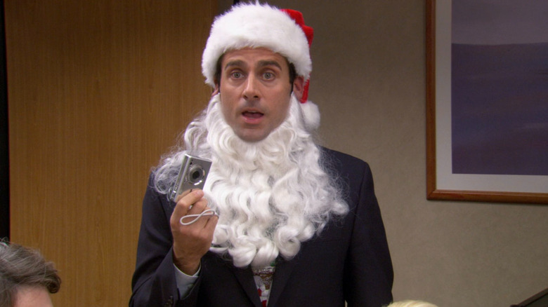 Michael (Steve Carell) dressed as Santa holding a camera on The Office