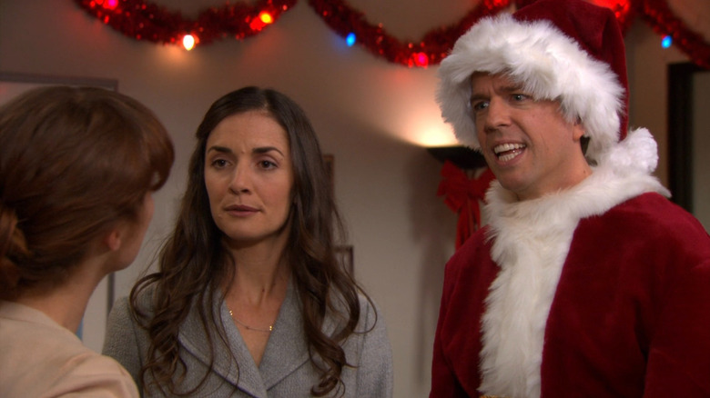 Andy (Ed Helms) and Jessica (Eleanor Siegler) looking bewildered at Erin (Ellie Kemper) on The Office