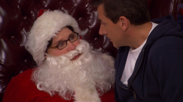 Michael (Steve Carell) sitting on Phyllis' (Phyllis Smith) lap while she's dressed as Santa on The Office