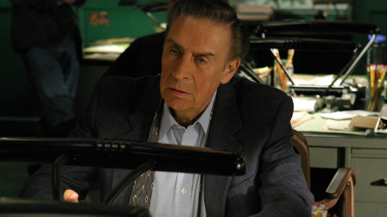 Lennie tiredly looks at junior detective Logan.