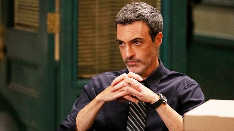 Law & Order Vincent Riley sits at his desk