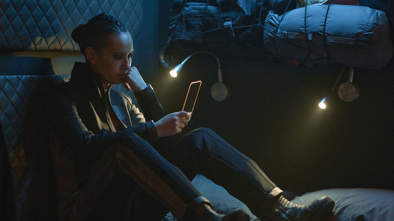 Camina Drummer looks at tablet on The Expanse