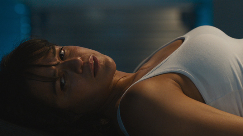 Letty laying down with head to the side in tank top