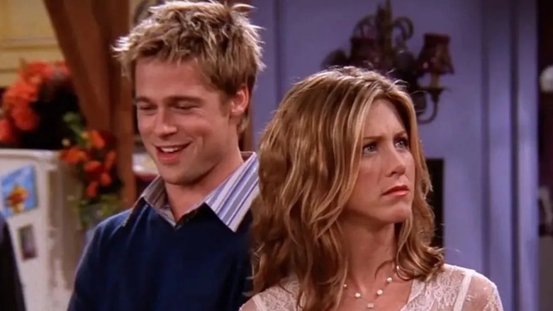 Will Colbert (Brad Pitt) laughs behind Rachel Green (Jennifer Aniston) in Friends