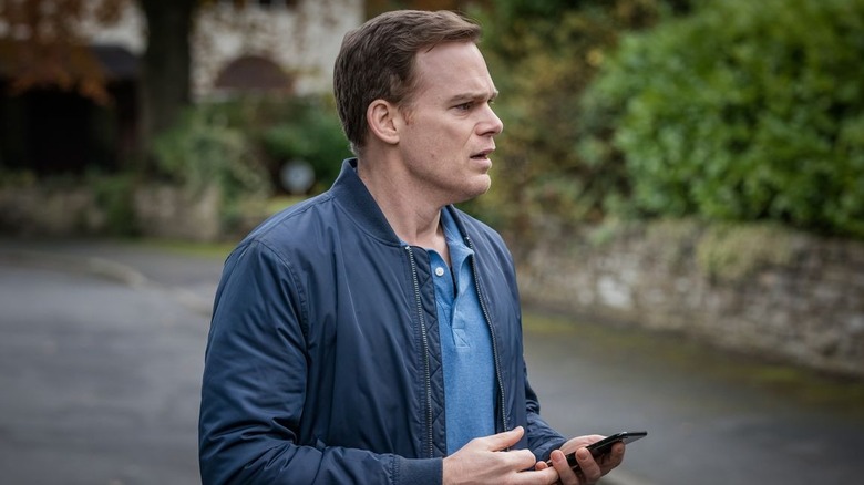 Michael C. Hall as Tom Delaney, holding his phone in the street in Safe