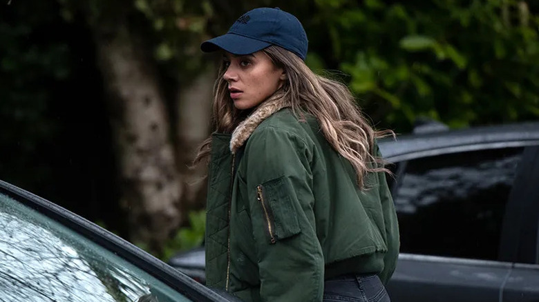 Hannah John-Kamen as the stranger walking to a car on The Stranger