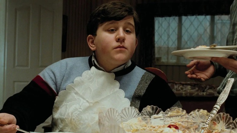 Harry Melling's Dudley Dursley sits for a feast in Harry Potter and the Prisoner of Azkaban