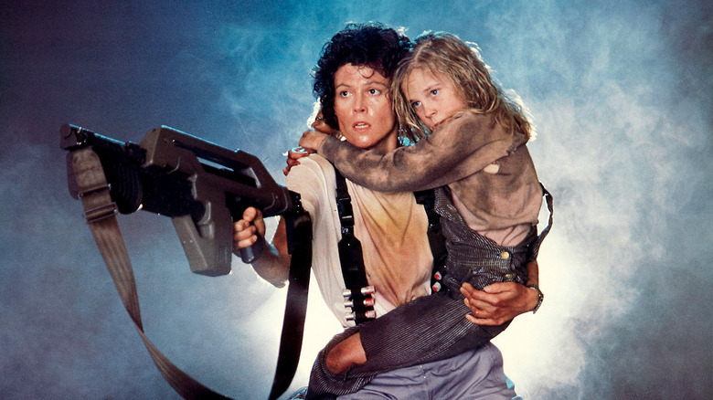 Sigourney Weaver and Carrie Henn hide from aliens in smoke