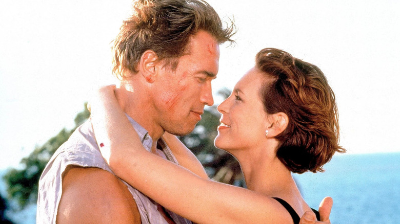 Arnold Schwarzenegger and Jamie Lee Curtis hug True Lies