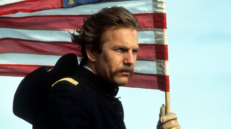 Dunbar (Kevin Costner) carrying an American flag in "Dances with Wolves."