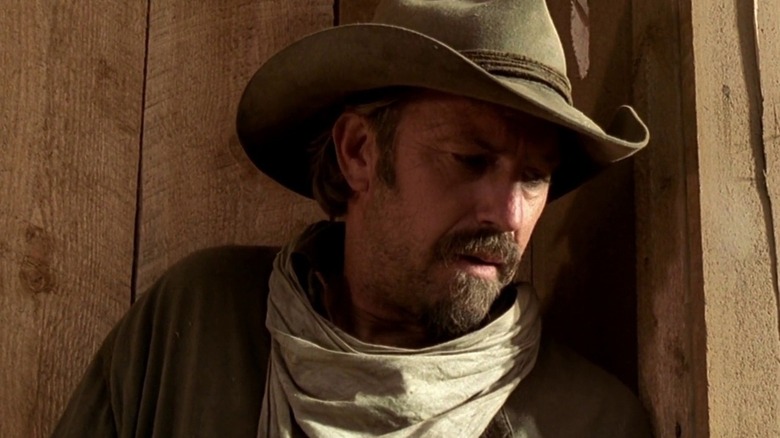 Charley (Kevin Costner) leaning against wooden panes in "Open Range."