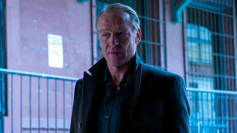 Bruce Wayne (Iain Glen) stands cautiously in an alley in Titans