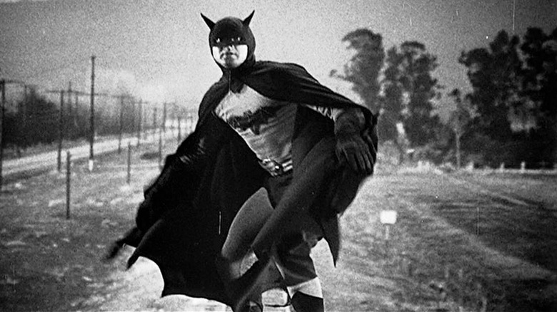 Batman (Robert Lowery) stands on top of a moving train in Batman and Robin