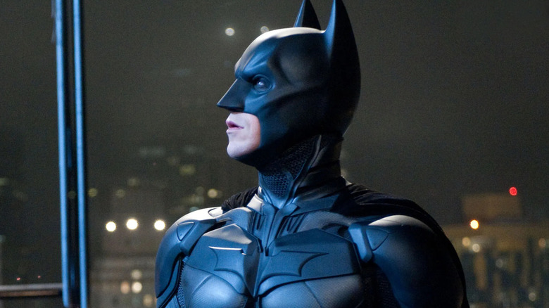 Christian Bale as Batman, looking up from a high rise, in The Dark Knight