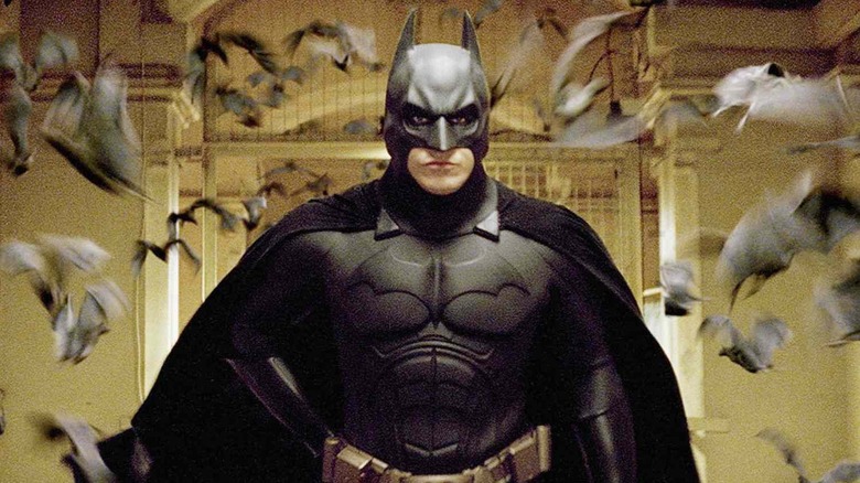 Christian Bale as Batman, running through bats, in Batman Begins