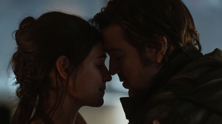 Cassian Andor and Bix Caleen leaning into each other in their apartment on Coruscant in Andor season 2