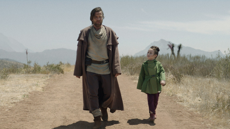 Obi-Wan walking down a dirt road with Princess Leia in the Obi-Wan Kenobi show