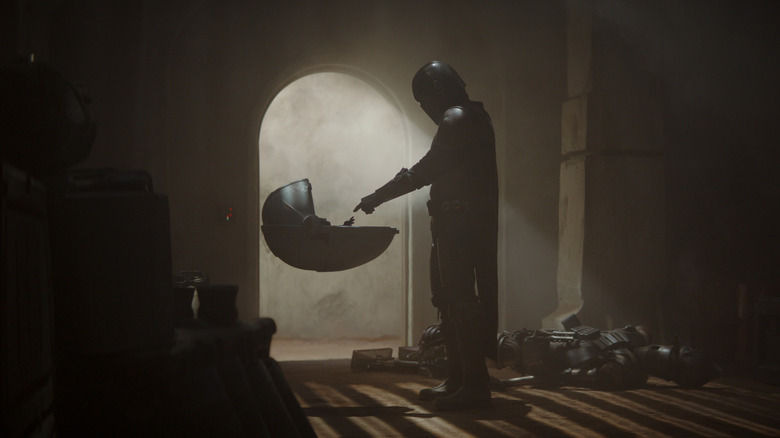 Din Djarin reaching out to Grogu in his hover-pod in The Mandalorian season 1