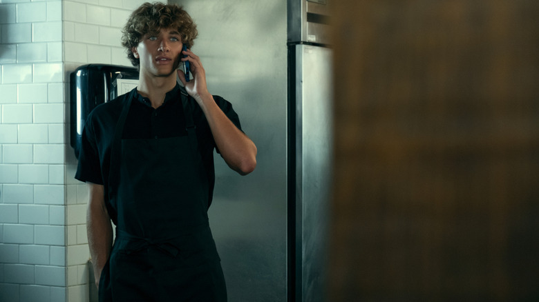 Jeremiah on the phone in an industrial kitchen on The Summer I Turned Pretty