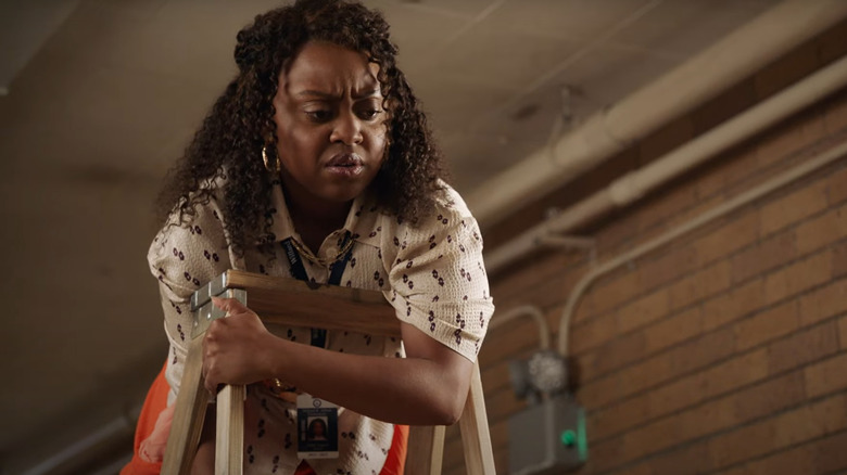 Abbott Elementary's Janine grimaces on a ladder