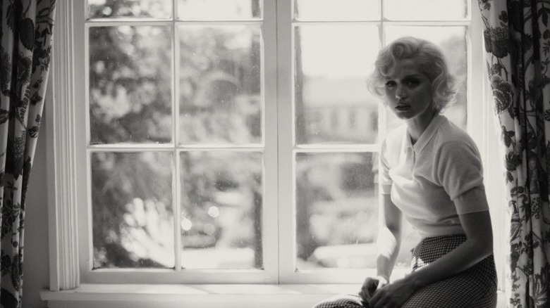 Norma Jeane sitting by a window