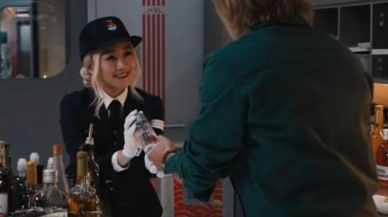 Karen Fukuhara hands drink to Brad Pitt