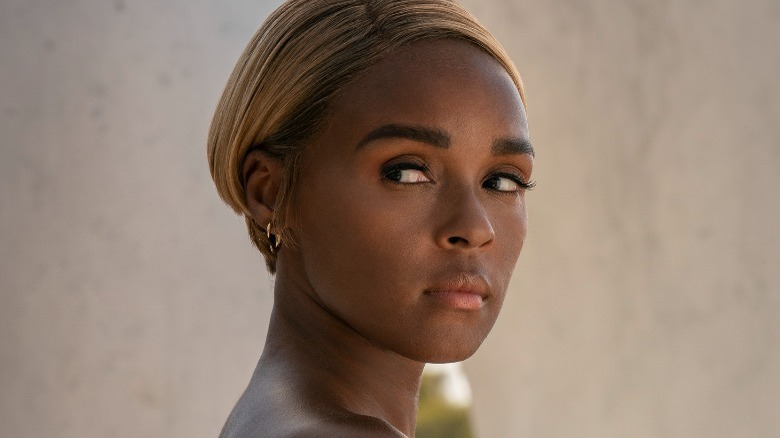 Janelle Monáe short blonde hair looking over shoulder