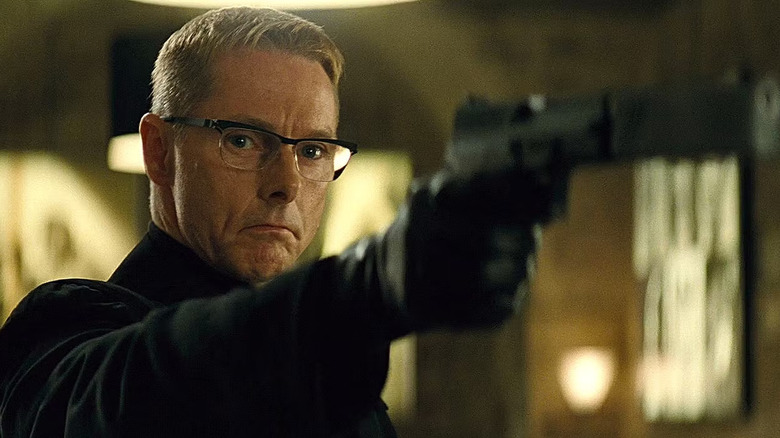 Sean Harris as Solomon Lane hoding a gun in Mission: Impossible – Rogue Nation