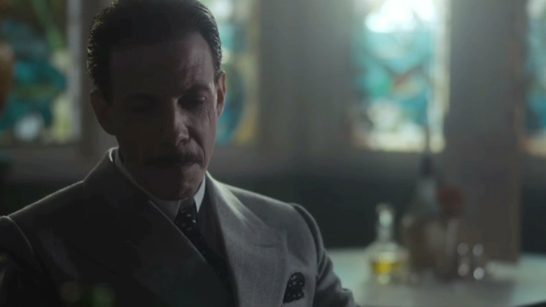 Noah Taylor's Darby Sabinin in a restaurant on Peaky Blinders
