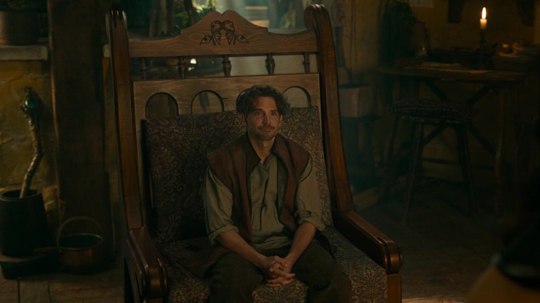 Marlamin (Bradley Cooper), a halfling, sits on a human-sized chair in his home in Dungeons & Dragons: Honor Among Thieves (2023)