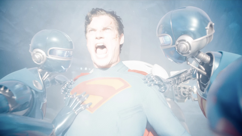 Clark Kent/Superman (David Corenswet) screams at exposure to yellow sun while being held back by two robots in Superman (2025).